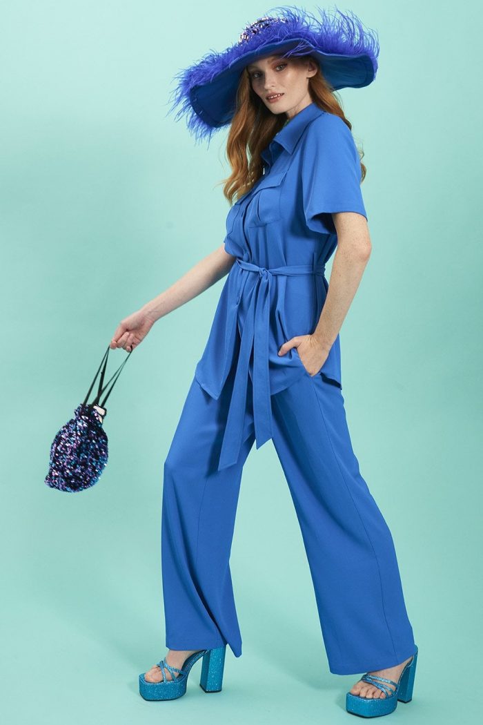 woman wears blue trouser suit