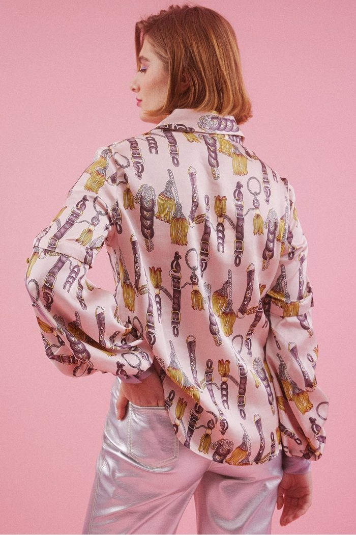 Woman facing away from the camera showing a silk blouse
