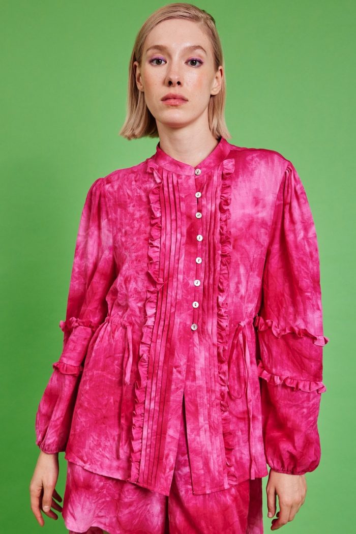 Woman wearing statement pink blouse